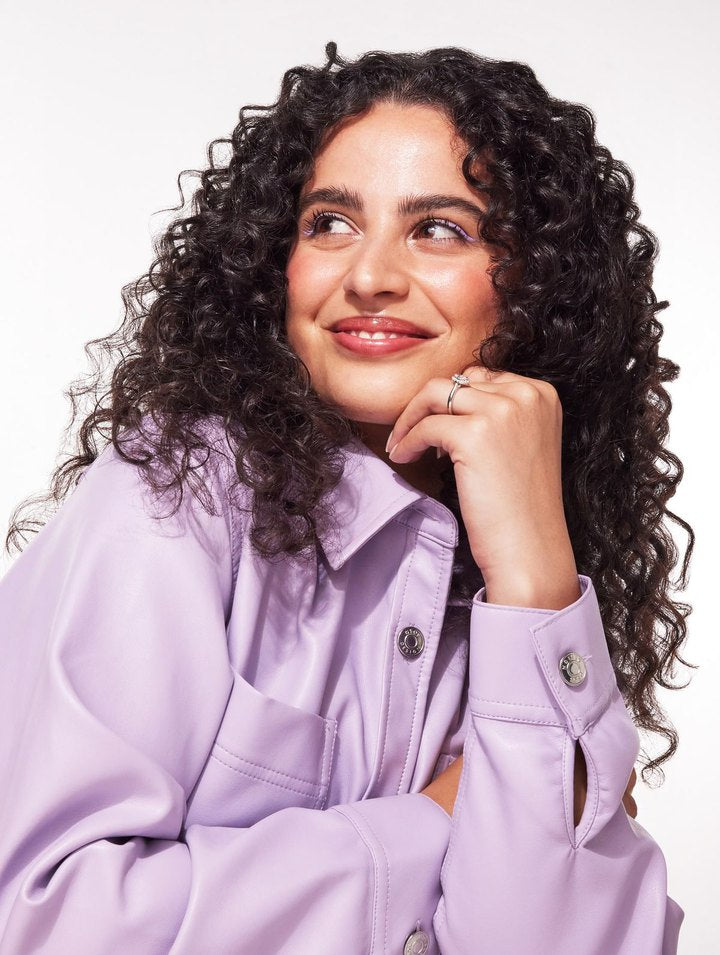 A woman in a lilac shirt